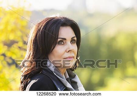 Stock Image - Portrait of a mature businesswoman outdoors in the river valley in autumn; Edmonton, Alberta, Canada. Fotosearch