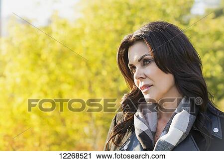 Stock Image - Portrait of a mature businesswoman outdoors in the river valley in autumn; Edmonton, Alberta, Canada. Fotosearch