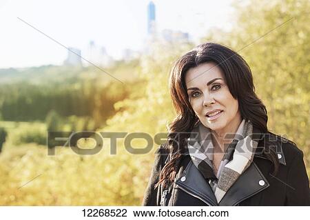 Portrait of a mature businesswoman outdoors in the river valley in autumn; Edmonton, Alberta, Canada View Large Photo Image Stock Image - Portrait of a mature businesswoman outdoors in the river valley in autumn; Edmonton, Alberta, Canada. Fotosearch