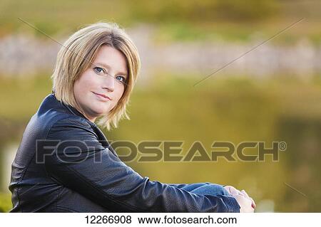 Portrait of a mature woman in a park in autumn; Edmonton, Alberta, Canada View Large Photo Image Stock Photo - Portrait of a mature woman in a park in autumn; Edmonton, Alberta, Canada. Fotosearch