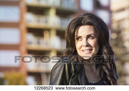 Stock Image - Portrait of a mature woman outdoors in an urban setting; Edmonton, Alberta, Canada. Fotosearch
