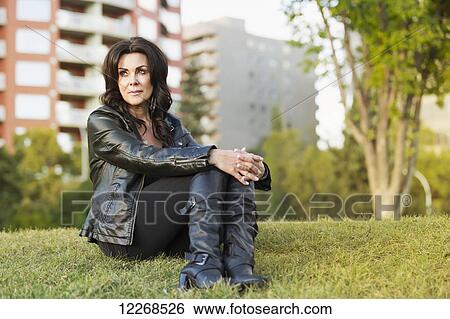 Stock Photograph - Portrait of a mature woman outdoors in an urban setting; Edmonton, Alberta, Canada. Fotosearch