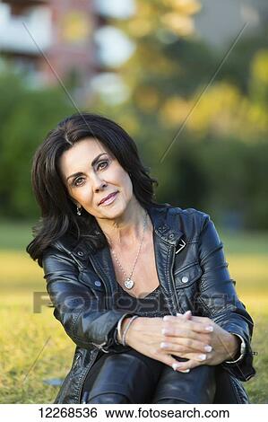 Portrait of a mature woman outdoors in an urban setting in autumn; Edmonton, Alberta, Canada View Large Photo Image Stock Photograph - Portrait of a mature woman outdoors in an urban setting in autumn; Edmonton, Alberta, Canada. Fotosearch