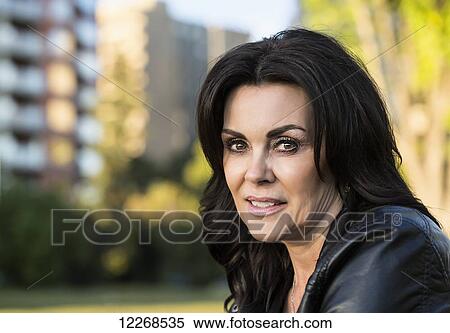 Portrait of a mature woman outdoors in an urban setting in autumn; Edmonton, Alberta, Canada View Large Photo Image Stock Photography - Portrait of a mature woman outdoors in an urban setting in autumn; Edmonton, Alberta, Canada. Fotosearch