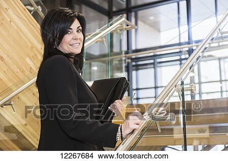Picture - Portrait of a professional businesswoman on stairway; Edmonton, Alberta, Canada. Fotosearch