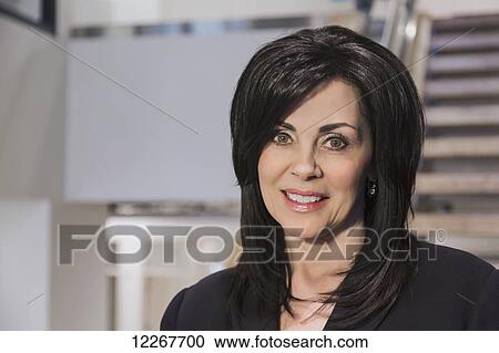 Stock Image - Portrait of a professional businesswoman in office setting; Edmonton, Alberta, Canada. Fotosearch