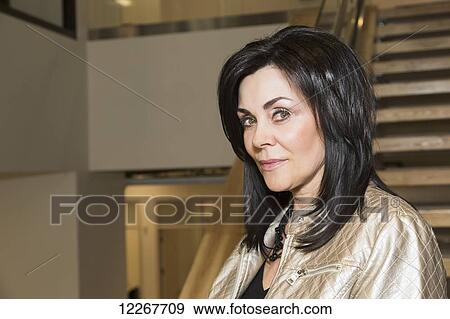Stock Photo - Portrait of a professional businesswoman in office setting; Edmonton, Alberta, Canada. Fotosearch
