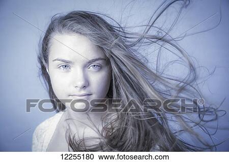 Stock Image - Portrait of a teenage girl with windswept hair; Connecticut, United States of America. Fotosearch