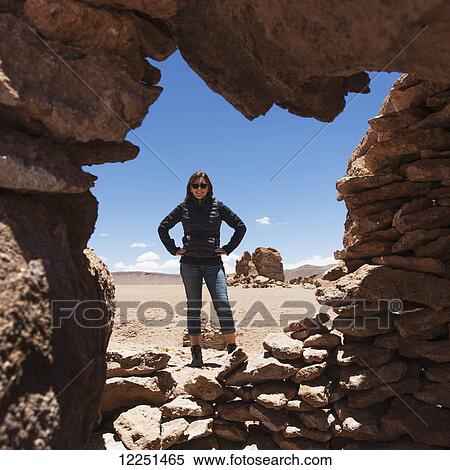Stock Photography - Portrait of a woman standing in Salar de Atacama; San Pedro de Atacama, Antofagasta Region, Chile. Fotosearch