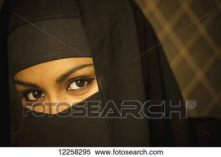 Stock Photography - Portrait of a woman wearing a black burka; Brunei. Fotosearch