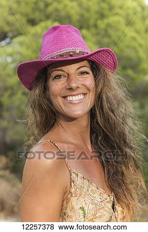 Portrait of a woman wearing a bright pink cowgirl hat; Tarifa, Cadiz, Andalusia, Spain View Large Photo Image Stock Photo - Portrait of a woman wearing a bright pink cowgirl hat; Tarifa, Cadiz, Andalusia, Spain. Fotosearch