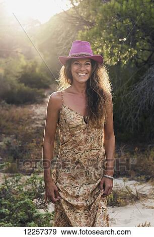 Stock Photo - Portrait of a woman wearing a bright pink cowgirl hat; Tarifa, Cadiz, Andalusia, Spain. Fotosearch