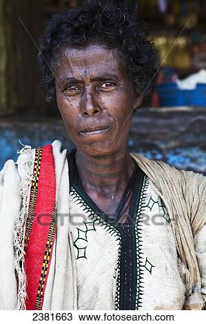 Stock Image - Portrait of a woman with a tattooed neck; Ethiopia. Fotosearch