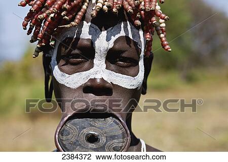 Portrait of a woman with painted white rings around her eyes and a lip plate; Omo Valley, Ethiopia View Large Photo Image Stock Image - Portrait of a woman with painted white rings around her eyes and a lip plate; Omo Valley, Ethiopia. Fotosearch