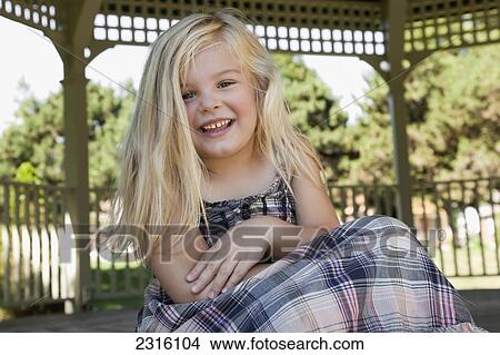 Picture - Portrait Of A Young Blonde Girl Laughing; Ontario Canada. Fotosearch
