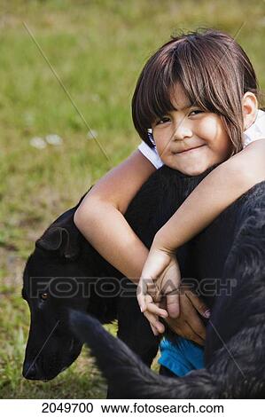 Stock Image - Portrait Of A Young Girl And A Dog, Kitwanga, Northern British Columbia. Fotosearch