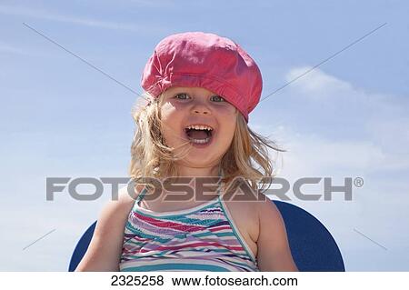 Portrait of a young girl laughing on a sunny summer day; Ontario canada View Large Photo Image Stock Photo - Portrait of a young girl laughing on a sunny summer day; Ontario canada. Fotosearch