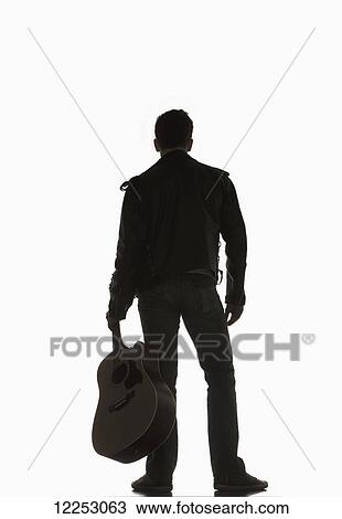 Stock Image - Portrait of a young man with his guitar; Edmonton, Alberta, Canada. Fotosearch