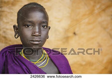 Stock Photograph - Portrait of a young Suri boy, Omo region, Southwest Ethiopia; Kibish, Ethiopia. Fotosearch