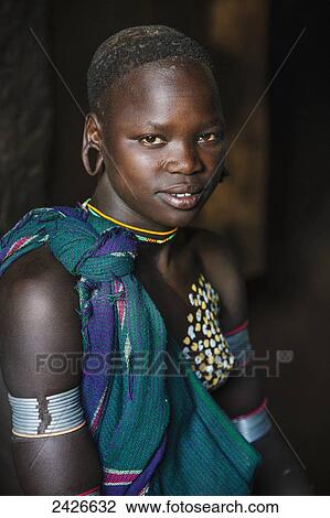Stock Image - Portrait of a young Suri woman, Omo region, Southwest Ethiopia; Kibish, Ethiopia. Fotosearch