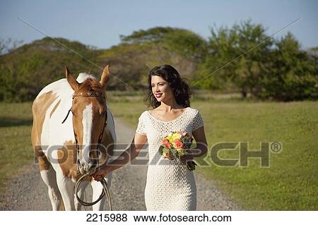 Stock Photo - Portrait of a young woman an her horse.. Fotosearch