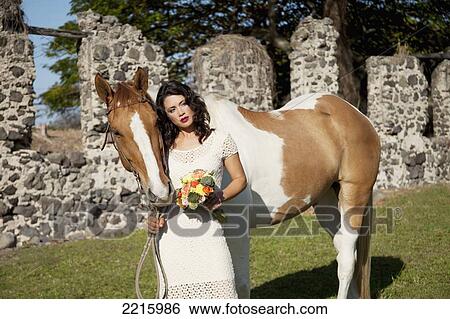 Stock Photograph - Portrait of a young woman an her horse.. Fotosearch