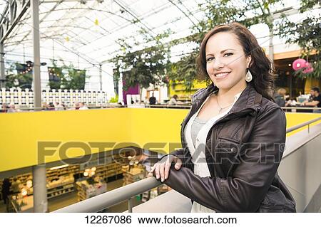 Stock Photograph - Portrait of a young woman at a shopping mall; St. Albert, Alberta, Canada. Fotosearch