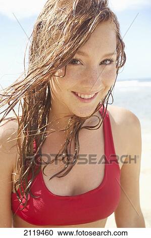 Stock Image - Portrait of a young woman at the ocean; Wailua, Hawaii, United States of America. Fotosearch
