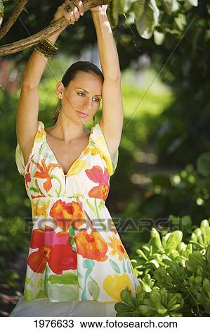 Stock Image - Portrait of a young woman in a floral shirt. Fotosearch