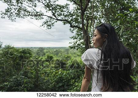 Portrait of a young woman in Phnom Bakheng, ancient buddhist temple from the famous Angkor area; Siem Reap, Cambodia View Large Photo Image Stock Image - Portrait of a young woman in Phnom Bakheng, ancient buddhist temple from the famous Angkor area; Siem Reap, Cambodia. Fotosearch
