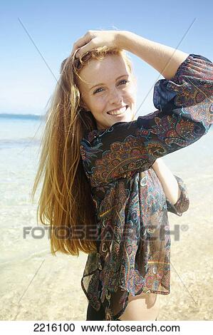 Portrait of a young woman on Tunnel's Beach; Kauai, Hawaii, United States of America View Large Photo Image Stock Image - Portrait of a young woman on Tunnel's Beach; Kauai, Hawaii, United States of America. Fotosearch