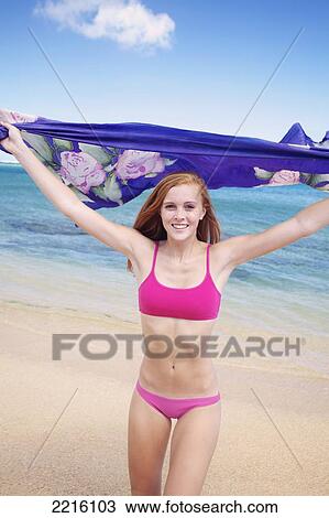 Portrait of a young woman on Tunnel's Beach; Kauai, Hawaii, United States of America View Large Photo Image Stock Image - Portrait of a young woman on Tunnel's Beach; Kauai, Hawaii, United States of America. Fotosearch