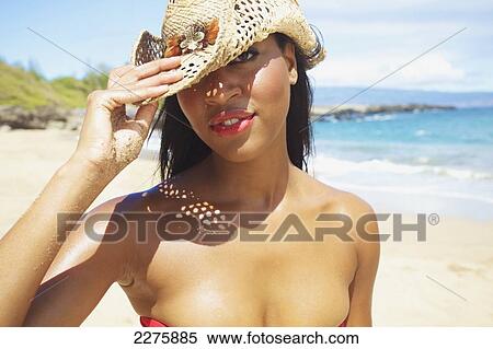 Portrait of a young woman wearing a sunhat on the beach; Maui, Hawaii, United States of America View Large Photo Image Stock Photography - Portrait of a young woman wearing a sunhat on the beach; Maui, Hawaii, United States of America. Fotosearch
