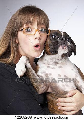 Stock Photo - Portrait of a young woman with her boxer dog; Edmonton, Alberta, Canada. Fotosearch