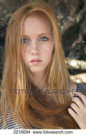 Portrait of a young woman with long red hair; Kauai, Hawaii, United States of America View Large Photo Image Picture - Portrait of a young woman with long red hair; Kauai, Hawaii, United States of America. Fotosearch