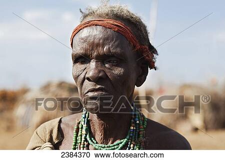 Stock Image - Portrait of an elderly man wearing colourful beaded jewelry; Omo Valley, Ethiopia. Fotosearch