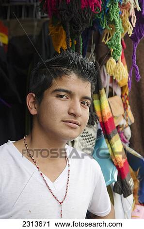 Portrait of boy standing in front of colorful scarves and hats; Guanajuato, Guanajuato State, Mexico View Large Photo Image Stock Image - Portrait of boy standing in front of colorful scarves and hats; Guanajuato, Guanajuato State, Mexico. Fotosearch