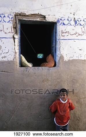 Stock Image - Portrait Of Boy With Television; Cairo, Egypt. Fotosearch