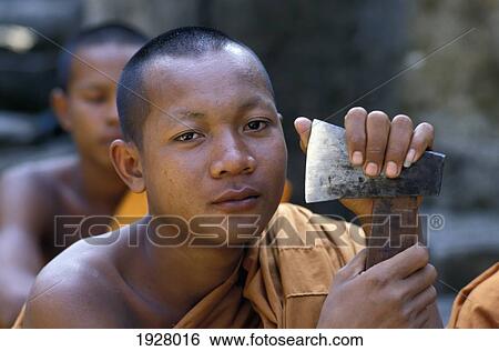 Portrait Of Buddhist Monk With Axe; Angkor Wat, Siem Reap, Cambodia View Large Photo Image Stock Photograph - Portrait Of Buddhist Monk With Axe; Angkor Wat, Siem Reap, Cambodia. Fotosearch