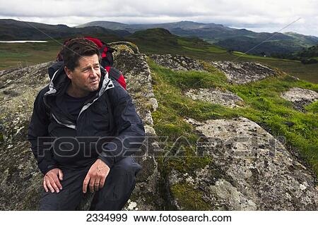 Stock Photo - Portrait Of Hiker Among Hills Of Western Lake District; Cumbria, England, Uk. Fotosearch