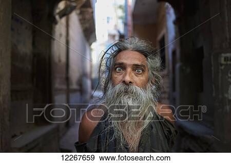 Stock Photo - Portrait of man in an alleyway; Jodhpur, Rajasthan, India. Fotosearch