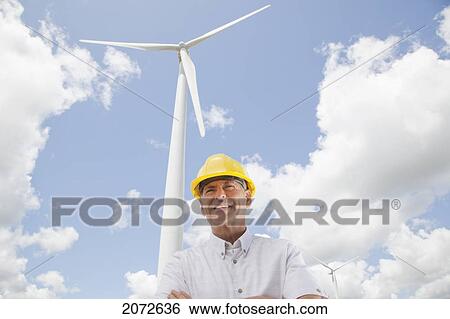 Stock Photograph - Portrait Of Man In Hard Hat On Wind Farm, Near Shelburne, Ontario. Fotosearch