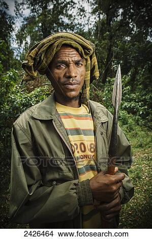 Portrait of man with spear out looking for his missing cattle, Western Highlands; Ethiopia View Large Photo Image Picture - Portrait of man with spear out looking for his missing cattle, Western Highlands; Ethiopia. Fotosearch