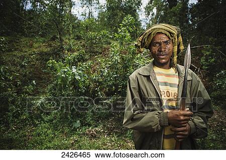 Portrait of man with spear out looking for his missing cattle, Western Highlands; Ethiopia View Large Photo Image Stock Photography - Portrait of man with spear out looking for his missing cattle, Western Highlands; Ethiopia. Fotosearch