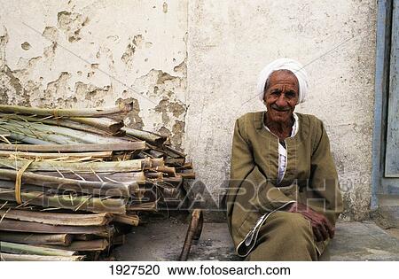 Portrait Of Old Man Sitting On Floor In Front Of Wall; Bahariya Oasis, Western Desert, Egypt View Large Photo Image Stock Image - Portrait Of Old Man Sitting On Floor In Front Of Wall; Bahariya Oasis, Western Desert, Egypt. Fotosearch