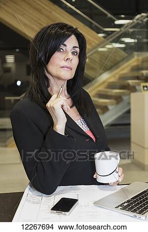Portrait of professional businesswoman in charge of construction work on office interior; Edmonton, Alberta, Canada View Large Photo Image Picture - Portrait of professional businesswoman in charge of construction work on office interior; Edmonton, Alberta, Canada. Fotosearch