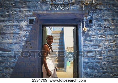Portrait Of Senior Man Leaning Against Blue Wall; Jodhpur, Rajasthan, India View Large Photo Image Stock Photo - Portrait Of Senior Man Leaning Against Blue Wall; Jodhpur, Rajasthan, India. Fotosearch