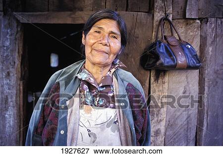 Stock Photo - Portrait Of Senior Pehuenche Woman In Front Of House. Fotosearch