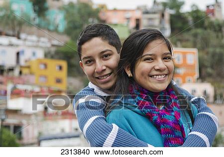 Stock Image - Portrait of siblings in front of suburbs houses; Guanajuato, Guanajuato, Mexico. Fotosearch