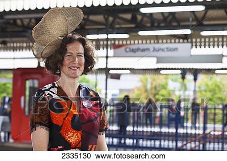 Portrait Of Woman At Clapham Junction Waiting For Train To Royal Ascot For Lady's Day; London, England, Uk View Large Photo Image Stock Image - Portrait Of Woman At Clapham Junction Waiting For Train To Royal Ascot For Lady's Day; London, England, Uk. Fotosearch
